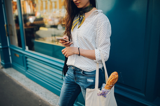 Young Parisian woman using the smartphone